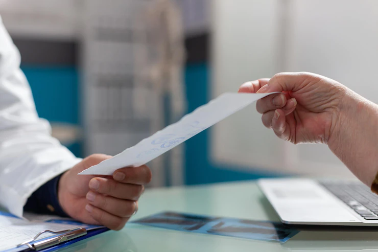 physician-giving-prescription-document-patient-cabinet-after-medical-consultation-medic-holding-checkup-report-give-treatment-retired-person-health-care-office-close-up_482257-33279